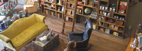 Yellow couch with a table and a brown armchair